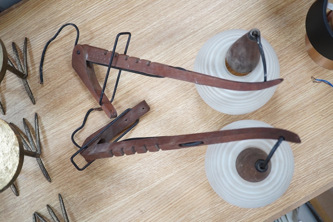 A pair of 1960s teak and opaque glass adjustable light fittings